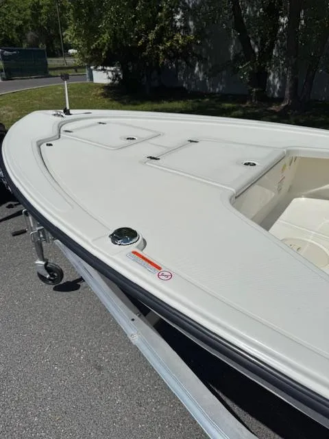 Slide: The Image of 2025 Mako 18 LTS boat on trailer, parked outdoors. - 8