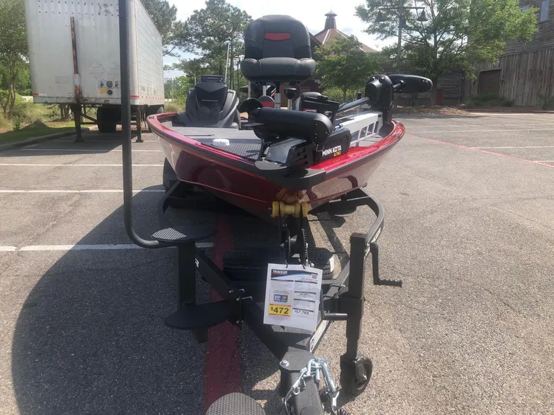 Slide: The Image of 2025 Tracker Savage 215 boat on trailer in parking lot, front view. - 2