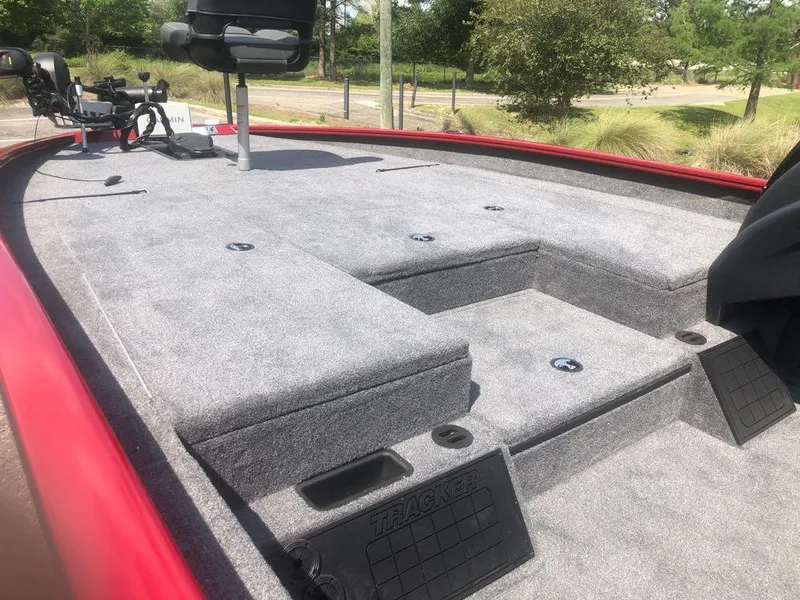 Slide: The Image of 2025 Tracker Savage 215 boat deck with seating and storage compartments. - 5