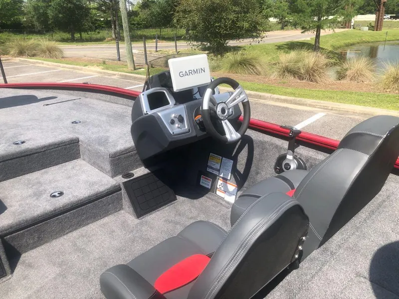 Slide: The Image of 2025 Tracker Savage 215 boat interior with Garmin navigation system and comfortable seating. - 8