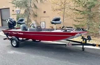 Slide: The Image of 2025 Tracker Bass Tracker Classic XL boat on trailer, parked outdoors. - 2