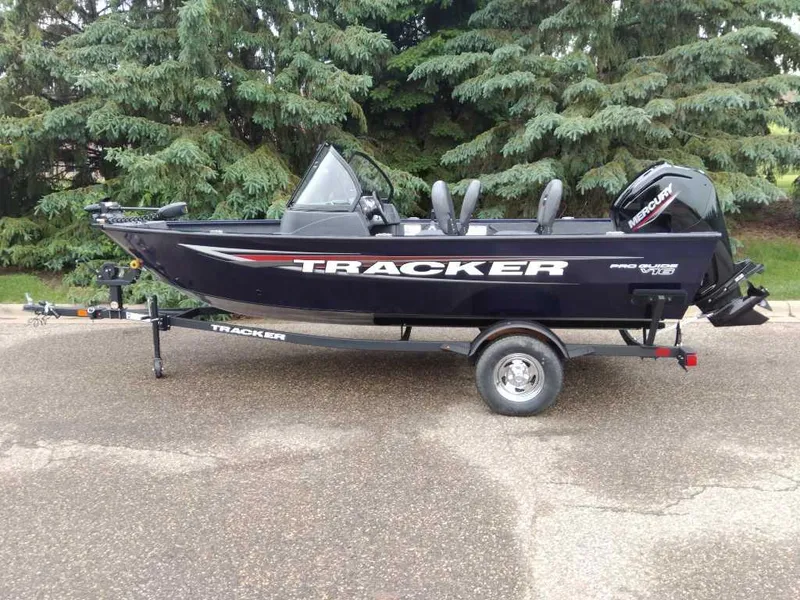 Slide: The Image of 2025 Tracker Pro Guide V-16 WT boat on trailer, parked outdoors. - 3
