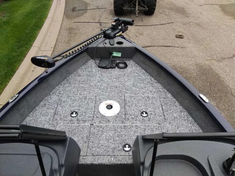 Slide: The Image of 2025 Tracker Pro Guide V-16 WT boat interior with fishing deck and trolling motor. - 4