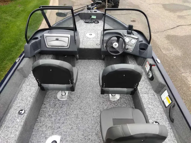 Slide: The Image of 2025 Tracker Pro Guide V-16 WT boat interior with dual seats and steering console. - 6