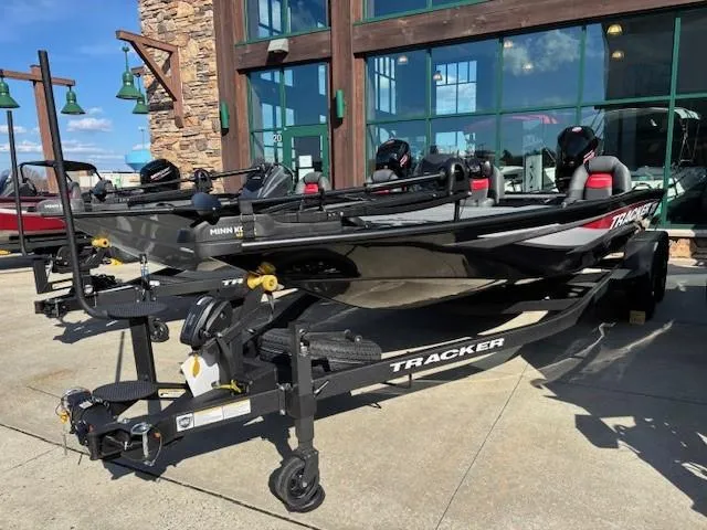 The Image of 2025 Tracker Savage 215 boat on trailer, displayed outdoors near a building. - 0