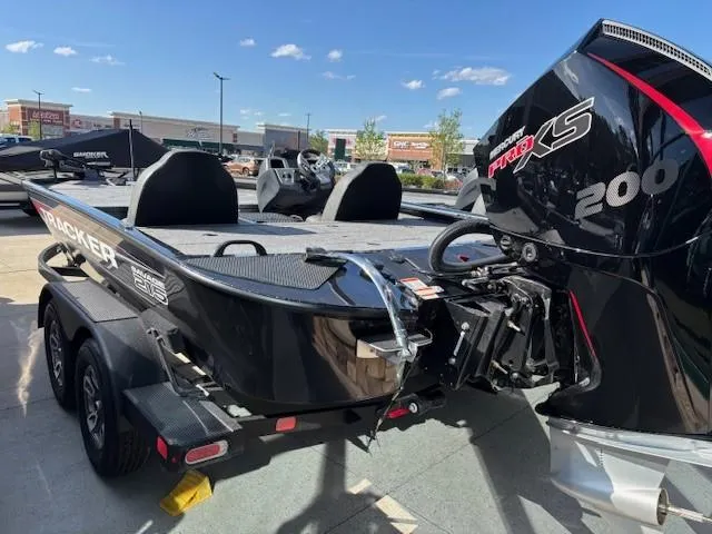 Slide: The Image of 2025 Tracker Savage 215 boat with powerful 200 Pro XS engine, parked on a trailer. - 2