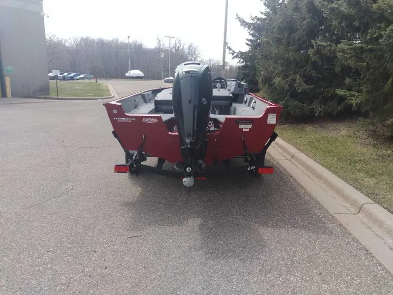 Slide: The Image of 2025 Tracker Pro Guide V-16 SC boat parked on a street, rear view. - 5