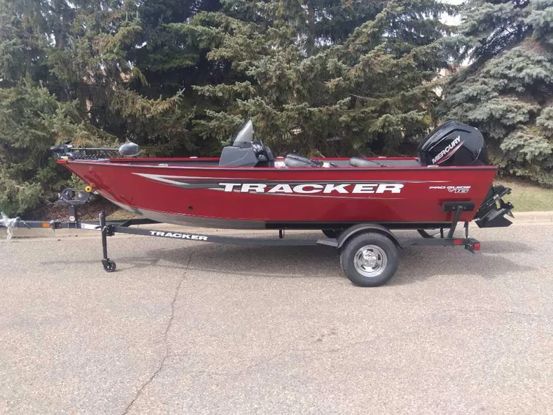 Slide: The Image of 2025 Tracker Pro Guide V-16 SC boat on trailer, parked outdoors. - 6