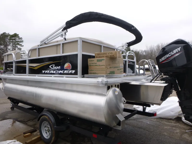 Slide: The Image of 2025 Sun Tracker Party Barge 16 DLX pontoon boat with Mercury engine on trailer. - 5