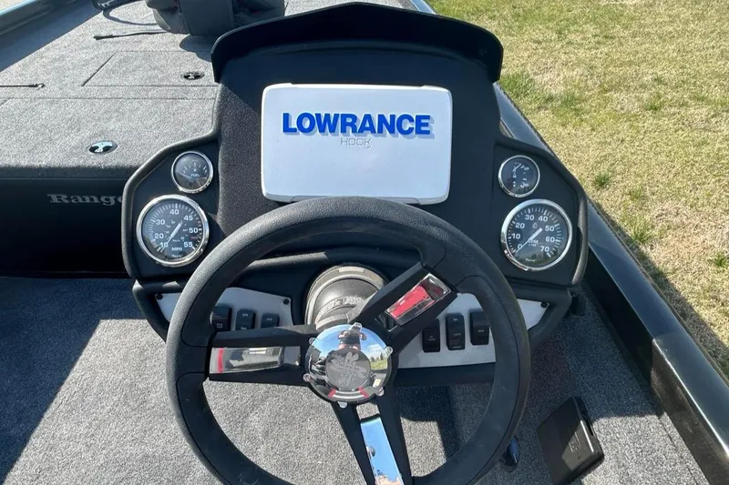 Slide: The Image of 2025 Ranger RT188C boat dashboard with Lowrance display and steering wheel. - 2