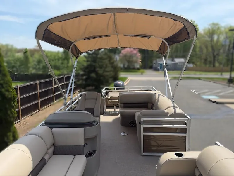 Slide: The Image of 2025 Sun Tracker SportFish 22 DLX pontoon boat with spacious seating and canopy. - 3