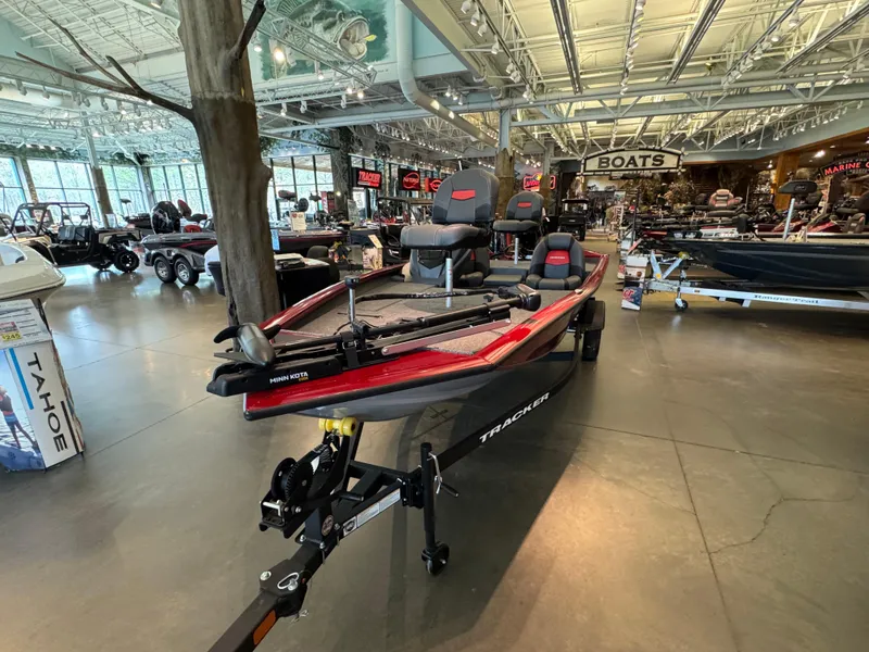Slide: The Image of 2025 Tracker Pro Team 175 boat displayed in a showroom with modern interior design. - 3