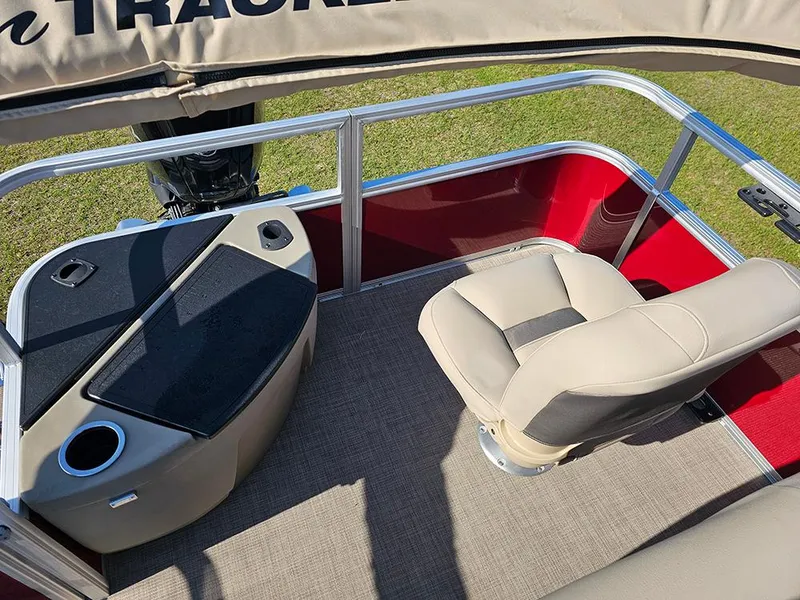 Slide: The Image of 2025 Sun Tracker Bass Buggy 18 DLX interior with beige seating and red paneling. - 10