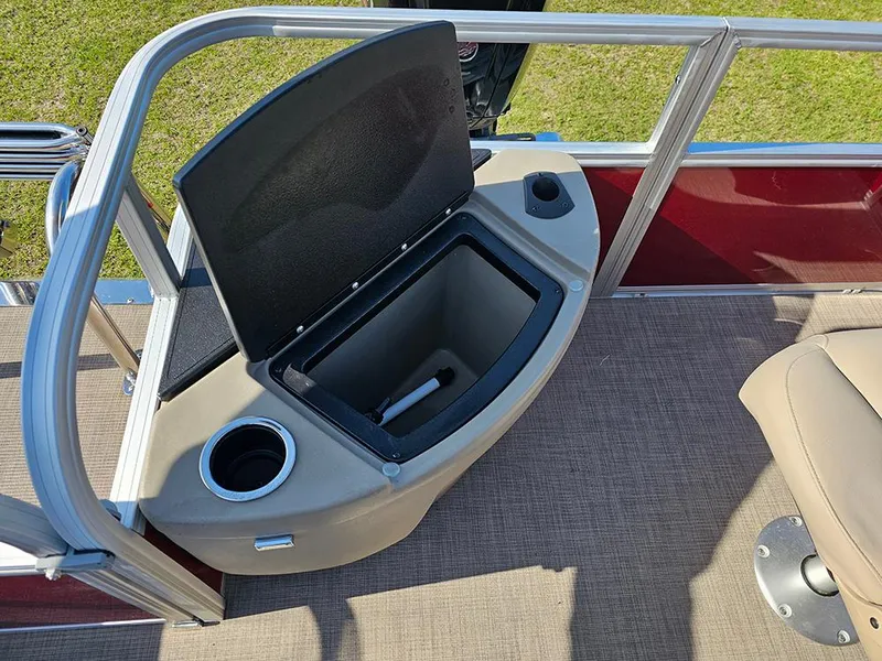 Slide: The Image of 2025 Sun Tracker Bass Buggy 18 DLX pontoon boat with open storage compartment and cup holder. - 11