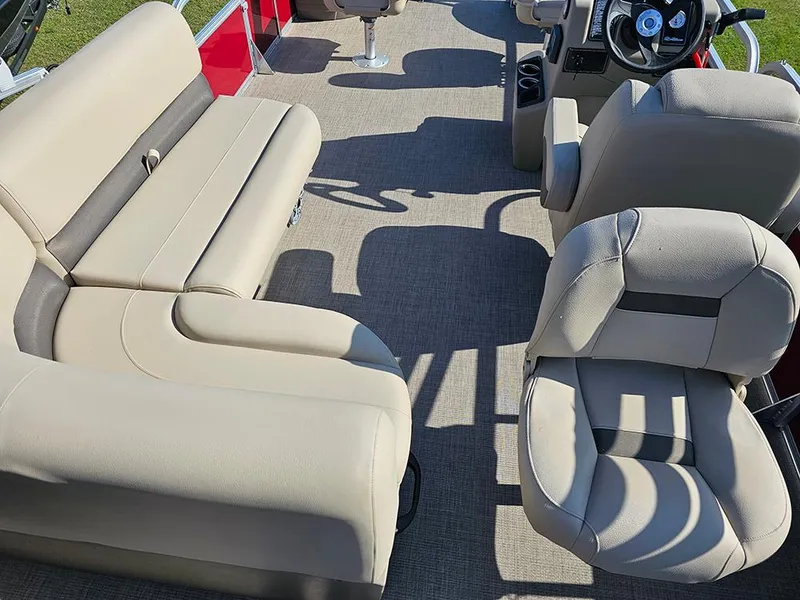 Slide: The Image of 2025 Sun Tracker Bass Buggy 18 DLX interior with beige seating and steering console. - 12