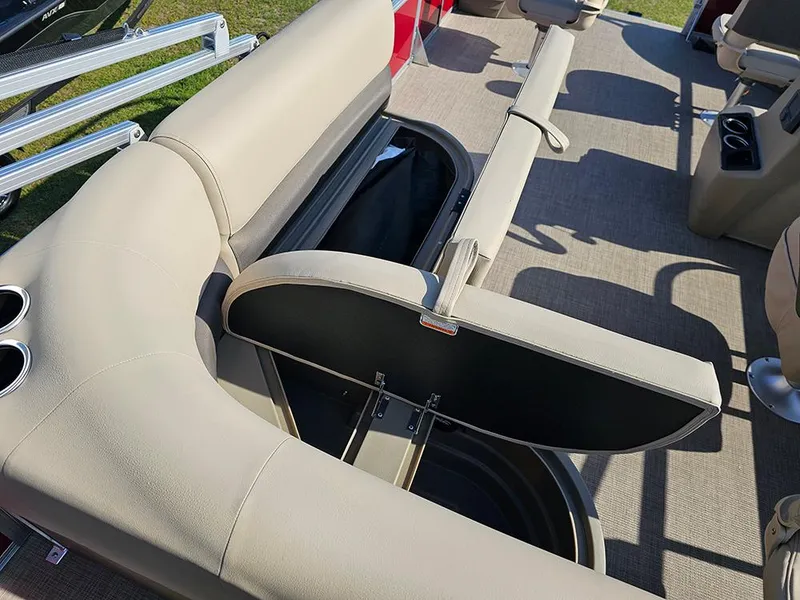 Slide: The Image of 2025 Sun Tracker Bass Buggy 18 DLX pontoon boat with open storage compartment and beige seating. - 13