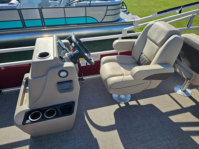 Slide: The Image of 2025 Sun Tracker Bass Buggy 18 DLX boat interior with captain's chair and steering console. - 14