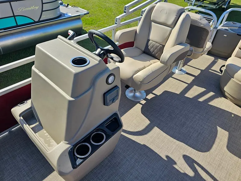 Slide: The Image of 2025 Sun Tracker Bass Buggy 18 DLX pontoon boat interior with helm and seating. - 17