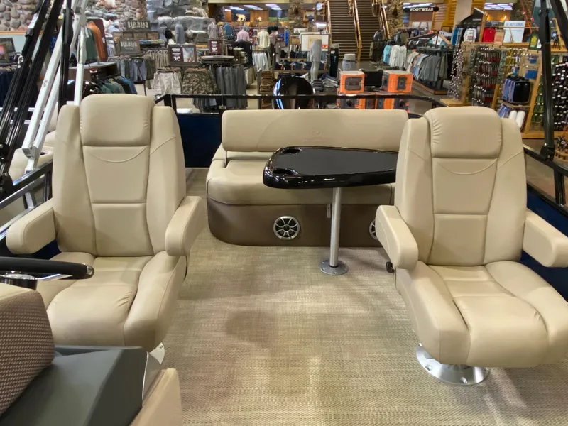 Slide: The Image of Luxurious interior of 2025 Regency 250 DL3 pontoon boat with beige seating and table. - 3