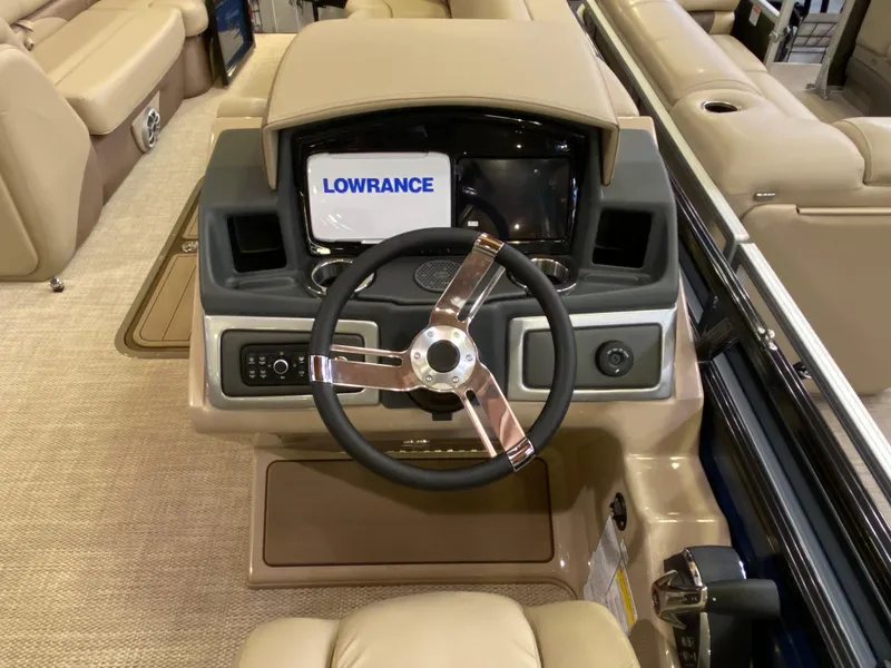 Slide: The Image of 2025 Regency 250 DL3 boat dashboard with Lowrance display and modern steering wheel. - 5