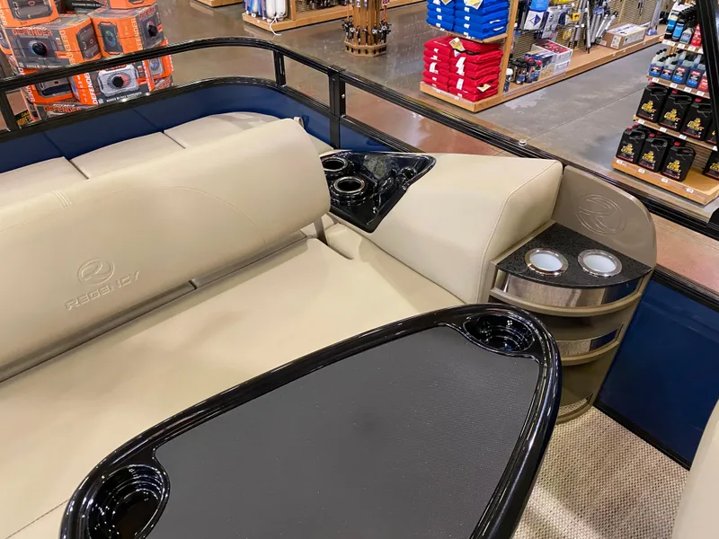 Slide: The Image of Luxurious seating area on 2025 Regency 250 DL3 boat with cup holders and table. - 6