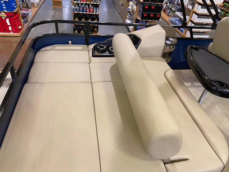 Slide: The Image of 2025 Regency 250 DL3 boat interior with beige seating and control panel. - 7