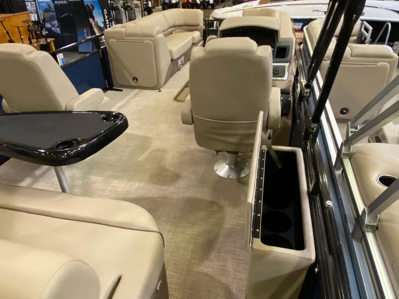 Slide: The Image of Luxurious interior of 2025 Regency 250 DL3 pontoon boat with beige seating and sleek design. - 8
