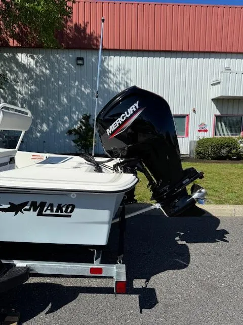 Slide: The Image of 2025 Mako Pro Skiff 17 CC with Mercury outboard motor, parked outdoors. - 2
