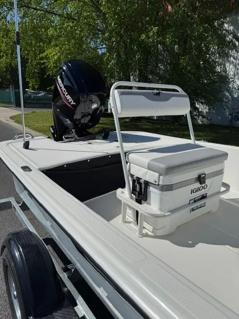 Slide: The Image of 2025 Mako Pro Skiff 17 CC boat with Mercury engine and Igloo cooler on trailer. - 5