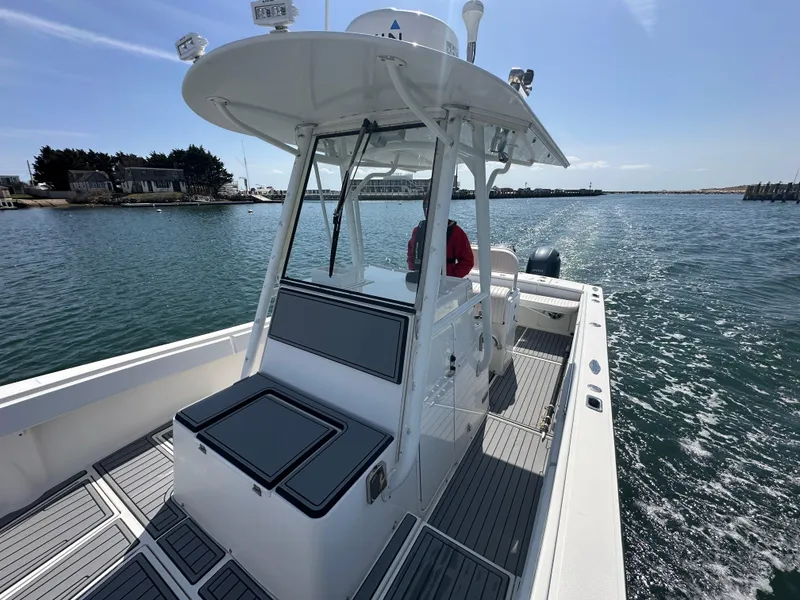 Slide: The Image of 2003 Regulator 26 Center Console boat cruising on a sunny day. - 15