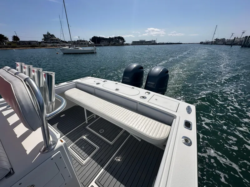 Slide: The Image of 2003 Regulator 26 Center Console boat with dual engines on a sunny day. - 17