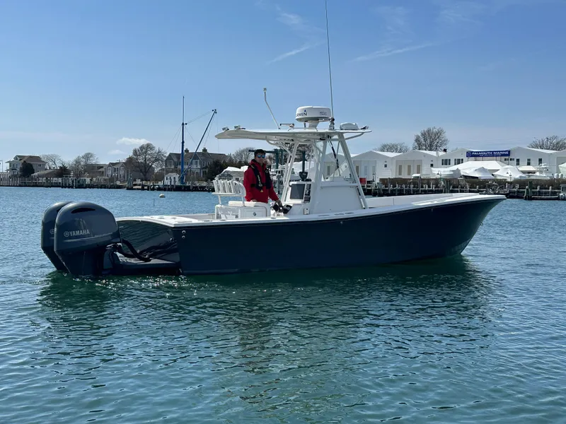 Slide: The Image of 2003 Regulator 26 Center Console boat on water with Yamaha outboard motor. - 9