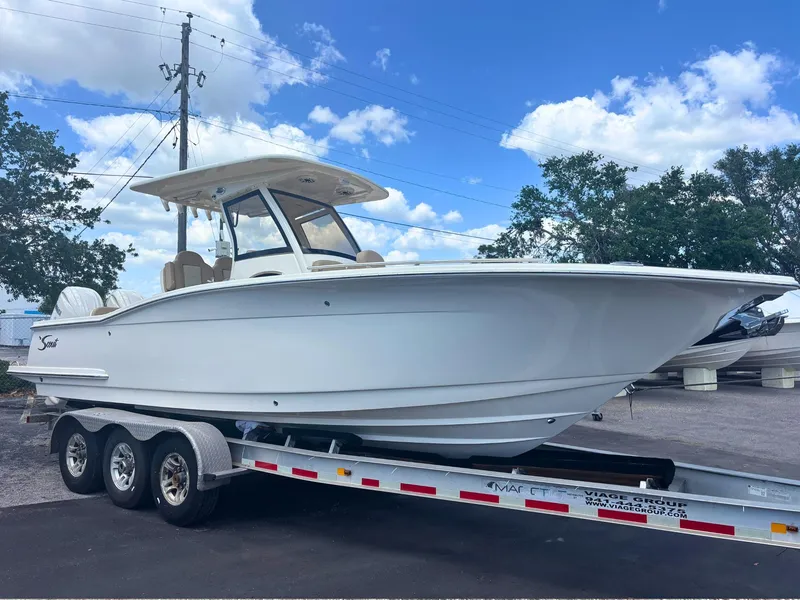The Image of 2025 Scout 277 LXF boat on trailer under blue sky. - 0