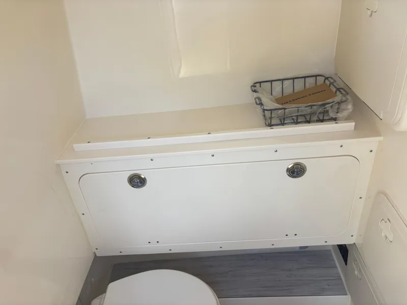 Slide: The Image of 2025 Scout 277 LXF boat interior with storage and toilet. - 12