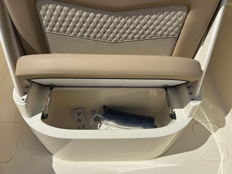 Slide: The Image of 2025 Scout 277 LXF boat seat with storage compartment open. - 16