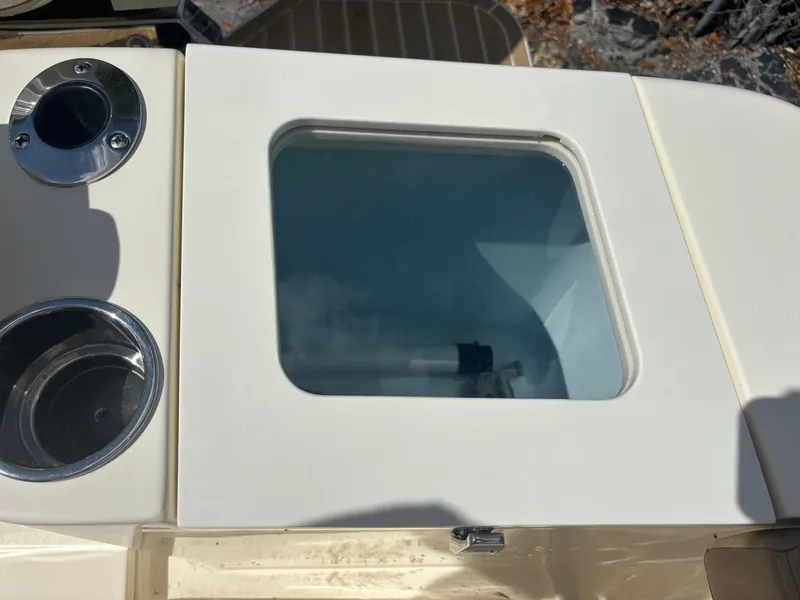 Slide: The Image of 2025 Scout 277 LXF boat detail with cup holders and storage compartment. - 18