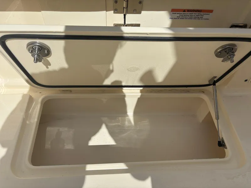 Slide: The Image of Open storage compartment on 2025 Scout 277 LXF boat. - 20