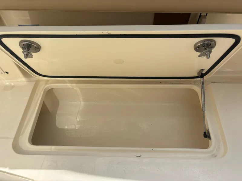 Slide: The Image of Open storage compartment on 2025 Scout 277 LXF boat. - 21