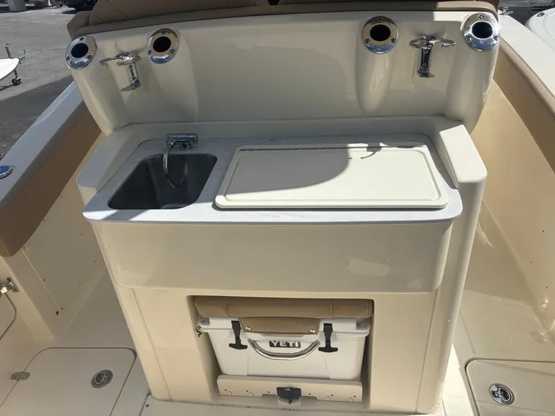 Slide: The Image of 2025 Scout 277 LXF boat with sink, storage, and Yeti cooler. - 5