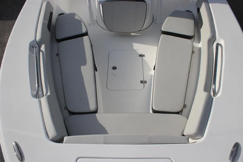 Slide: The Image of 2025 Sea Pro 202 CC boat interior with cushioned seating and storage hatch. - 14