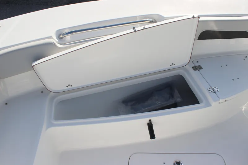 Slide: The Image of 2025 Sea Pro 202 CC boat storage compartment with open lid, showcasing interior space. - 7