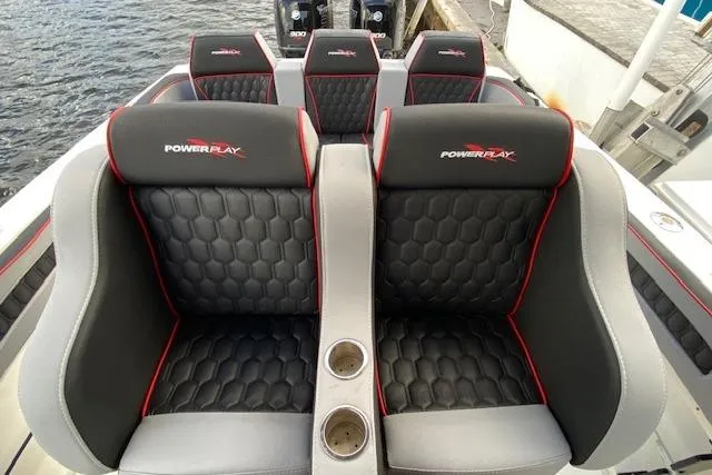 Slide: The Image of 1996 Powerplay Powerboats 33 Sportfish interior with stylish black and gray seating. - 12