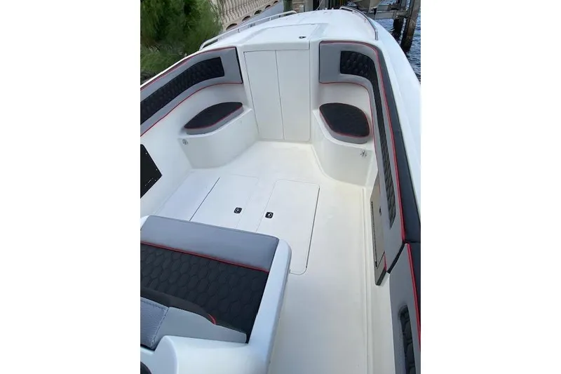 Slide: The Image of 1996 Powerplay Powerboats 33 Sportfish interior with cushioned seating and storage compartments. - 15