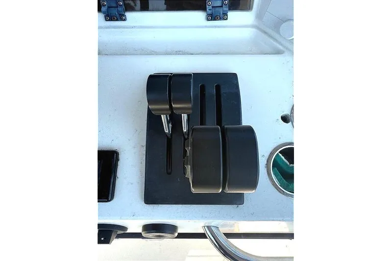 Slide: The Image of Throttle controls on a 1996 Powerplay Powerboats 33 Sportfish dashboard. - 18