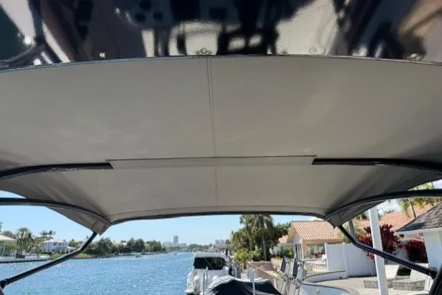 Slide: The Image of 1996 Powerplay Powerboats 33 Sportfish canopy with waterfront view. - 23
