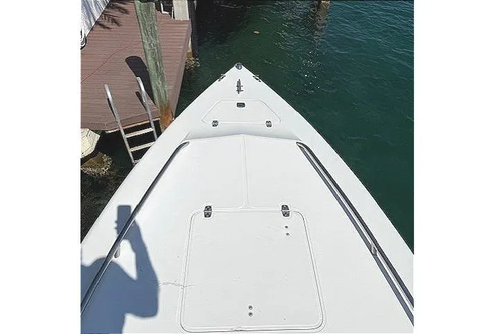 Slide: The Image of 1996 Powerplay Powerboats 33 Sportfish bow view at dockside. - 25