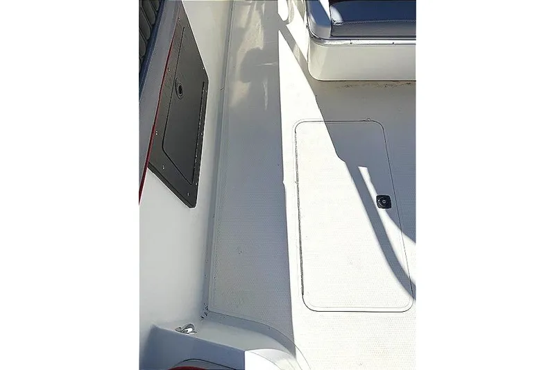 Slide: The Image of 1996 Powerplay Powerboats 33 Sportfish deck with storage compartments and seating. - 27