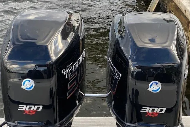 Slide: The Image of Twin Mercury 300 XS outboard engines on a 1996 Powerplay Powerboats 33 Sportfish. - 30