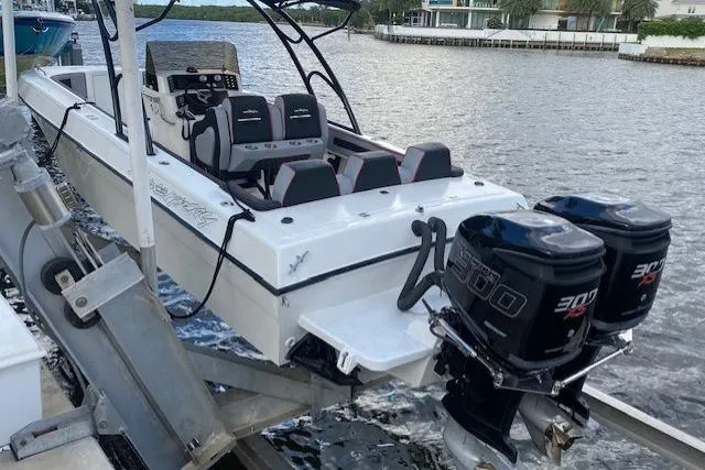 Slide: The Image of 1996 Powerplay Powerboats 33 Sportfish with dual 300 horsepower engines docked by the water. - 4