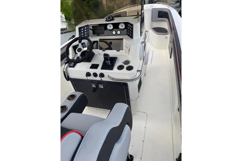 Slide: The Image of 1996 Powerplay Powerboats 33 Sportfish cockpit with steering wheel and control panel. - 7